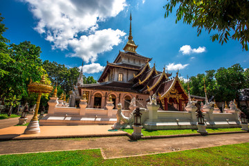 Naklejka premium background,Open view of the temple at Dara Pirom Temple (Mae Rim),which has a large statue in front of the temple. Covered by trees and sky, Chiang Mai Province, Thailand, Wat Pa Daphirom