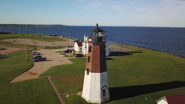 Sunset aerial orbit of Lighthouse at Point Judith