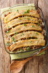 Freshly baked pastelon de Platano Maduro casserole close-up in a baking dish. Vertical top view