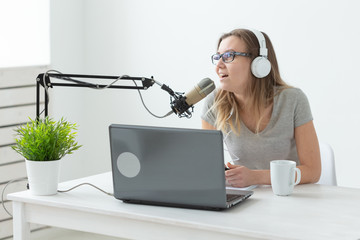 Radio, blogging, broadcast concept - woman dj is working on the radio