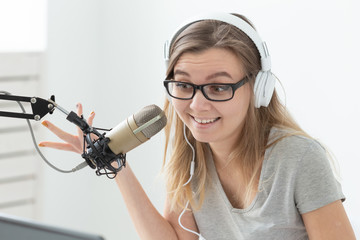 Naklejka premium Radio, blogging, podcasting concept - close-up of young woman working as a dj on the radio.
