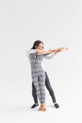 Social dance, bachata, kizomba, tango, salsa, people concept - Young couple dancing over white...