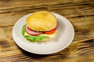 Fresh delicious homemade cheeseburger on wooden table