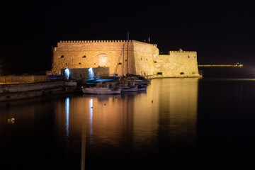 View of old harbour of Heraklion with Venetian Koules Fortress at the night. Crete, Greece. Heraklion by night. Koule fort at Iraklion, night.