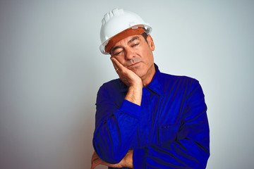 Handsome middle age worker man wearing uniform and helmet over isolated white background thinking looking tired and bored with depression problems with crossed arms.