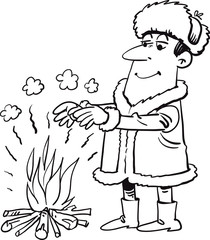 Warmly dressed man warming his hands by the fire.