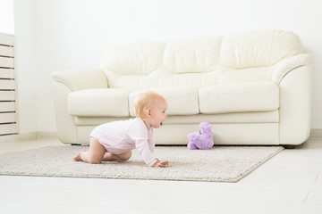 Smiling crawling baby girl at home on floor