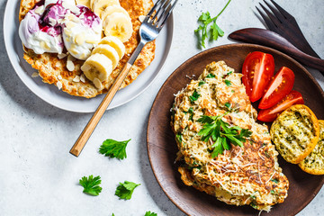 Oatmeal omelet with cheese and sweet oatmeal pancake, top view. Healthy breakfast concept.
