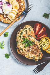 Oatmeal omelet with cheese and sweet oatmeal pancake, top view. Healthy breakfast concept.