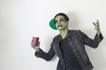Zombie man holding party cup.