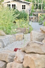 Grey garden house and gravel path