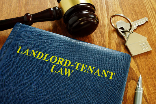 Landlord Tenant Law Book And Key From Home.