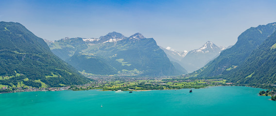 Naklejka na ściany i meble Panoramic view on green Swiss Alps near lake Lucerne, Altdorf village