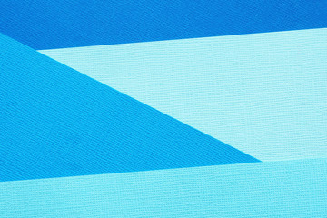 Abstract background and texture of four blue paper in different shades..