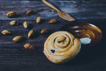 Fototapeta na wymiar Bread Denis with Chocolate chips with almond on wood background.