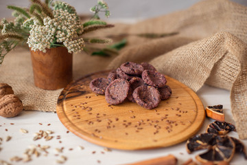 Sweets on a wooden tray around which are natural ingredients. Sugar-free dessert, healthy eating. Candies for diabetics.