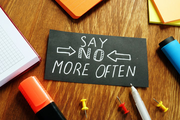 Learn to say no more often sign on the piece of paper.