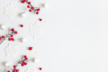 Christmas or winter composition. Snowflakes and red berries on gray background. Christmas, winter, new year concept. Flat lay, top view, copy space - 294318646