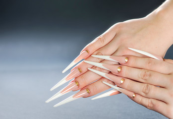 Beautiful long woman nails. White long nails. Special manicure skill.