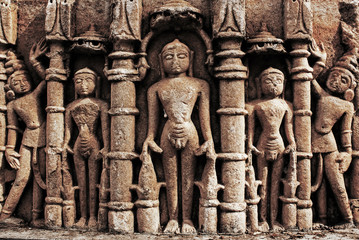 Ancient statues carved into the wall of a temple