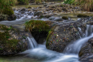 Flowing mountain stream with stones
