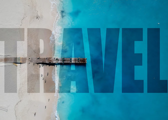 Drone photo of pier in Grace Bay, Providenciales, Turks and Caicos. Text overlay says travel