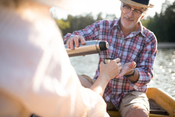 Caring husband pouring some tea into cup for his wife