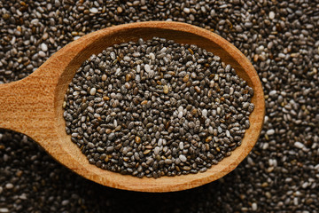 chia seeds in wooden spoon. chia seeds background