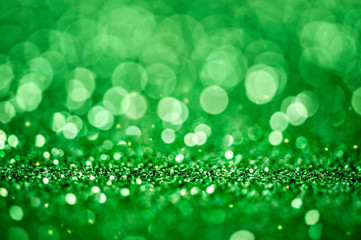 Green shiny glitters background. Green abstract texture.