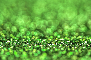 Green shiny glitters background. Green abstract texture.