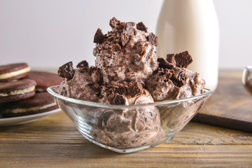 Glass with tasty ice cream on table