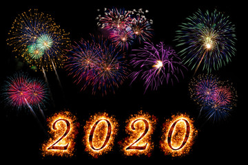 Happy New Year 2020 letters with sparkle and fireworks on black background