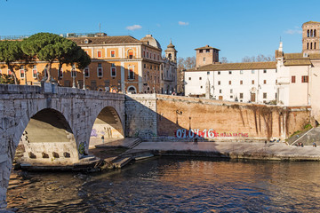 Fototapeta premium Riverfront view on Rome and stone bridge, Ponte Cestio on Tiber river in Rome. Italy