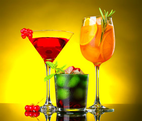 Different tasty cocktails on dark color background