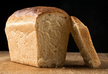 Loaf of white bread on an oak board