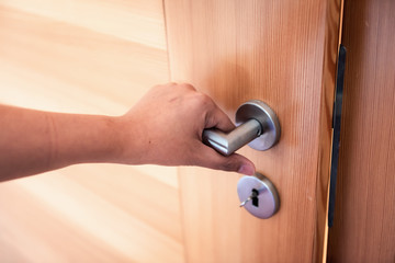 Woman Hand is Holding Door Knob While Opening a Door in Bedroom, Lock Security System and Access Safety of Doorway., Interior Design of Doorknob Entering to Accessibility Private Room - obrazy, fototapety, plakaty