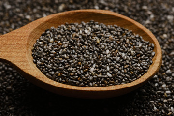 chia seeds in wooden spoon. chia seeds background