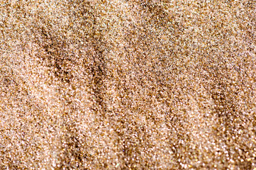 Gold background. Golden glitters for graphic design. Gold sand