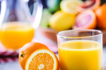 Orange juice in jar. Tropical fruits juice in glass with orange, lime and grep.