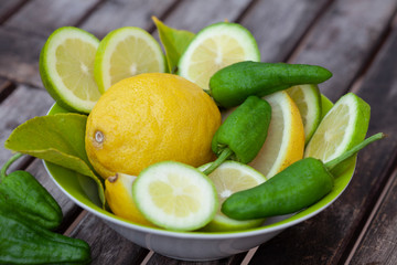 Fresh Picked Lemon And Peppers On Rustic Table