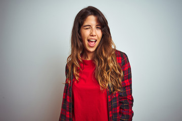 Young beautiful woman wearing red t-shirt and jacket standing over white isolated background...