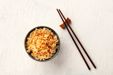Instant soba noodles with scalliions, carrot, and a sauce, shot from above with chopsticks and a place for text