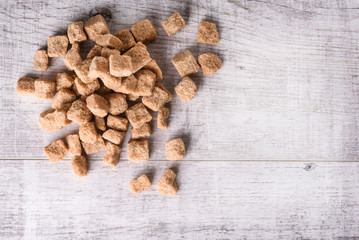 Brown sugar in small glass bowl. Beautiful cubes of brown sugar. Sweet and healthy sugar.