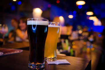 Light and dark beer on bar counter
