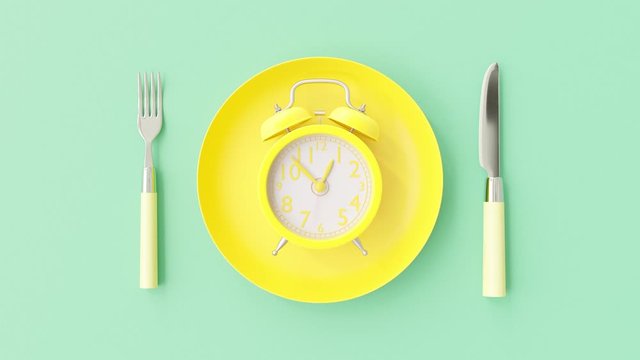 Yellow clock on yellow plate with fork and knife blue-green background, Break time idea concept. The beginning of time 12.45 run fast to 01.00. Timelapse moving fast, 3D Render.