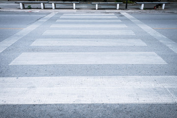Grunge crosswalk for pedestrians crossing the street. Crosswalks are designed to keep pedestrians when they can cross most safely across the flow of vehicular traffic.