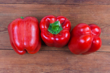 Top view of red bell peppers on the rustic table
