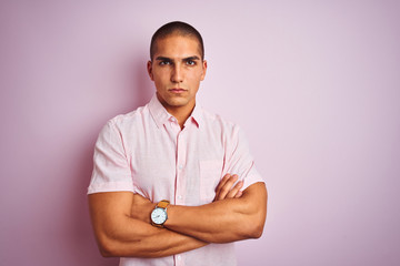 Young handsome man wearing elegant shirt over pink isolated background skeptic and nervous,...