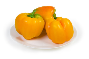 Yellow bell peppers on the dish on a white background