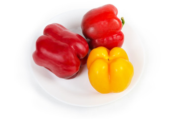 Red and yellow bell peppers on the white dish